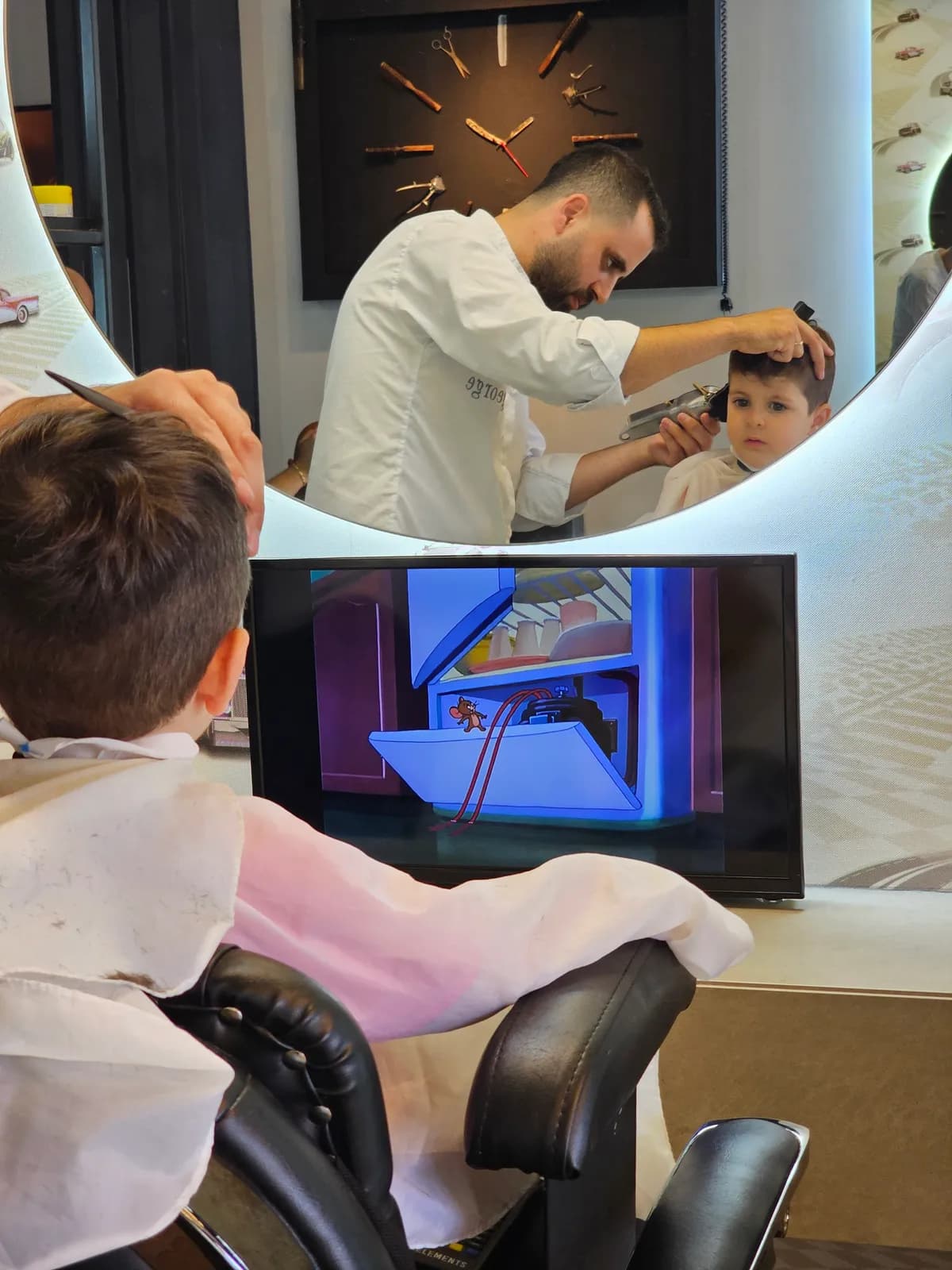 Barber giving a child a haircut